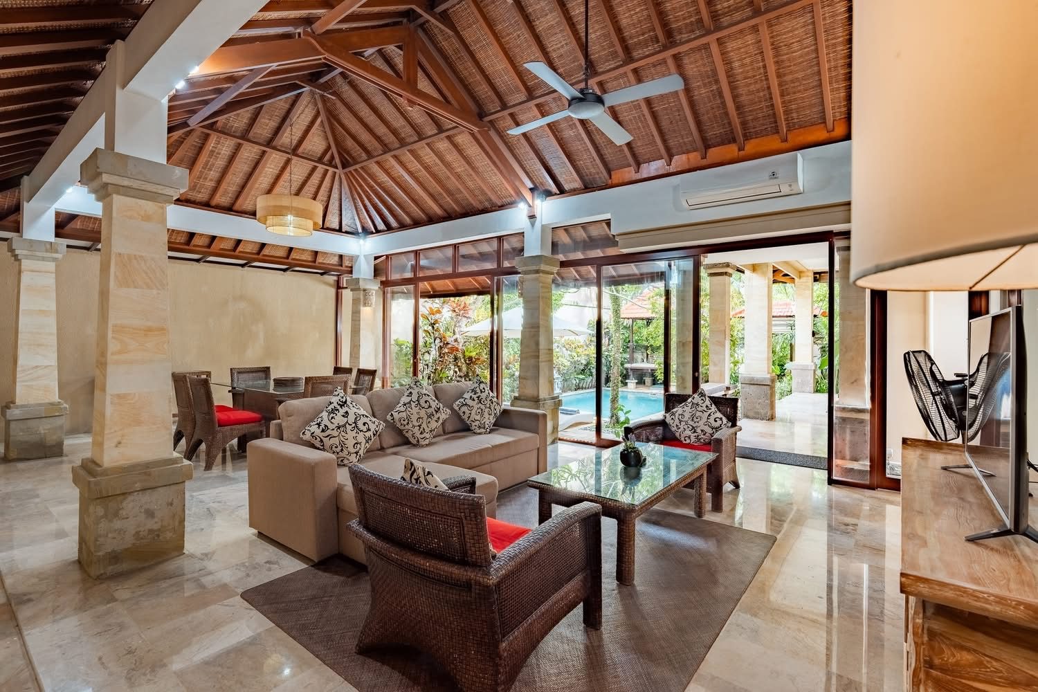 Open-plan living pavilion opening to the pool
