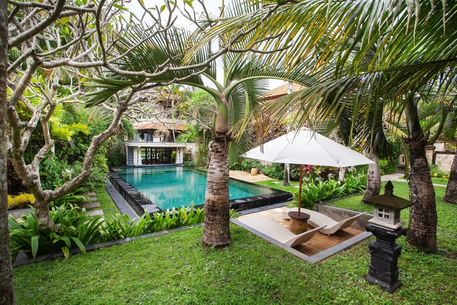 Poolside sun loungers and Balinese gazebo