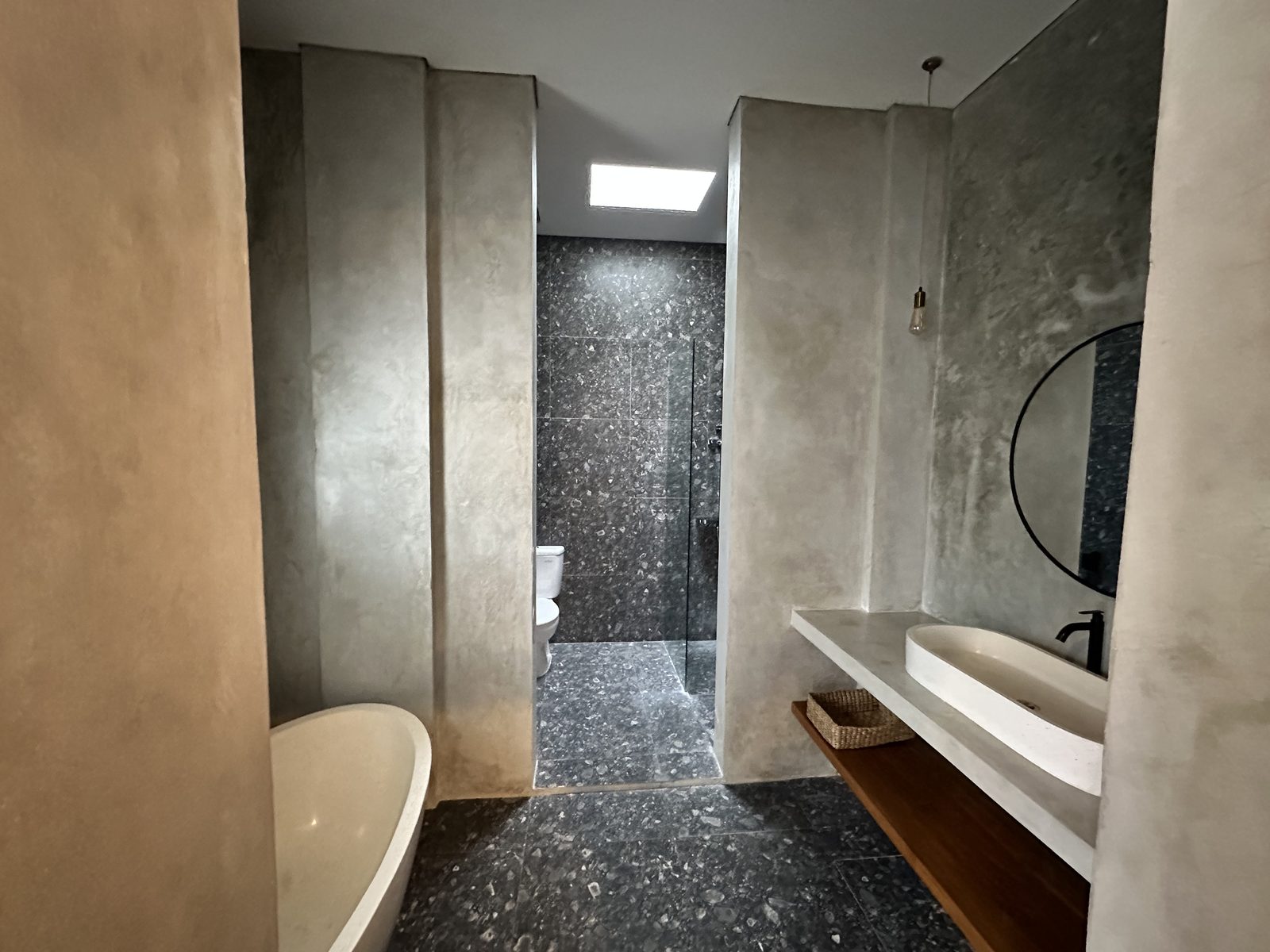 Terrazzo ensuite bathroom with freestanding tub